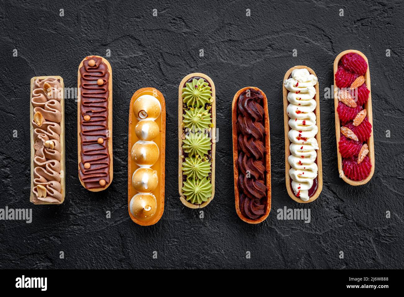 Sweet food pattern of eclairs with color topping. Sweet shacks Stock ...