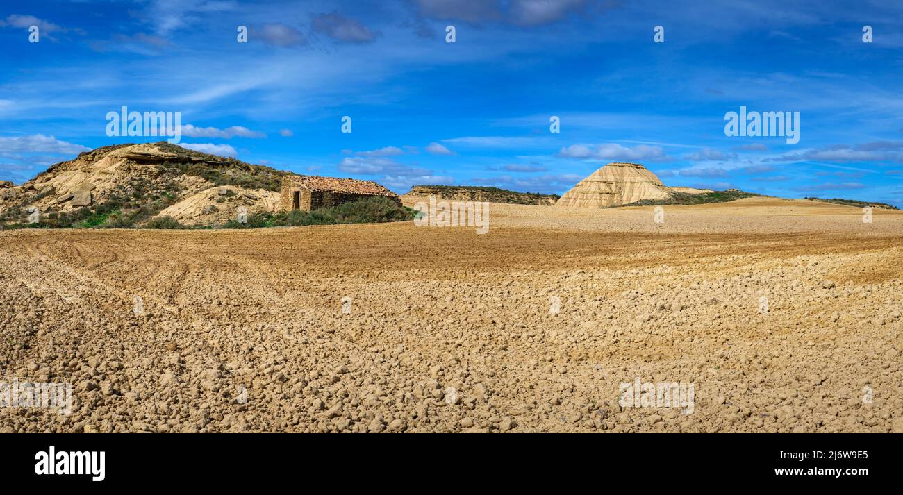 Desert landscape with farmland in front, Bardenas reales national park, Navarro, Spain. Stock Photo