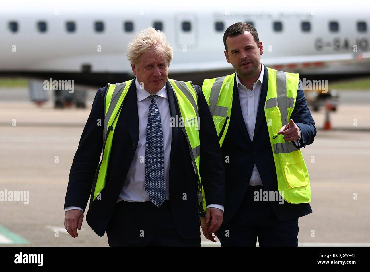 Prime Minister Boris Johnson speaks with Conservative MP for Eastleigh Paul Holmes, on the tarmac of Southampton airport during a visit to the Eastleigh constituency, while on the local elections campaign trail. Picture date: Wednesday May 4, 2022. Stock Photo
