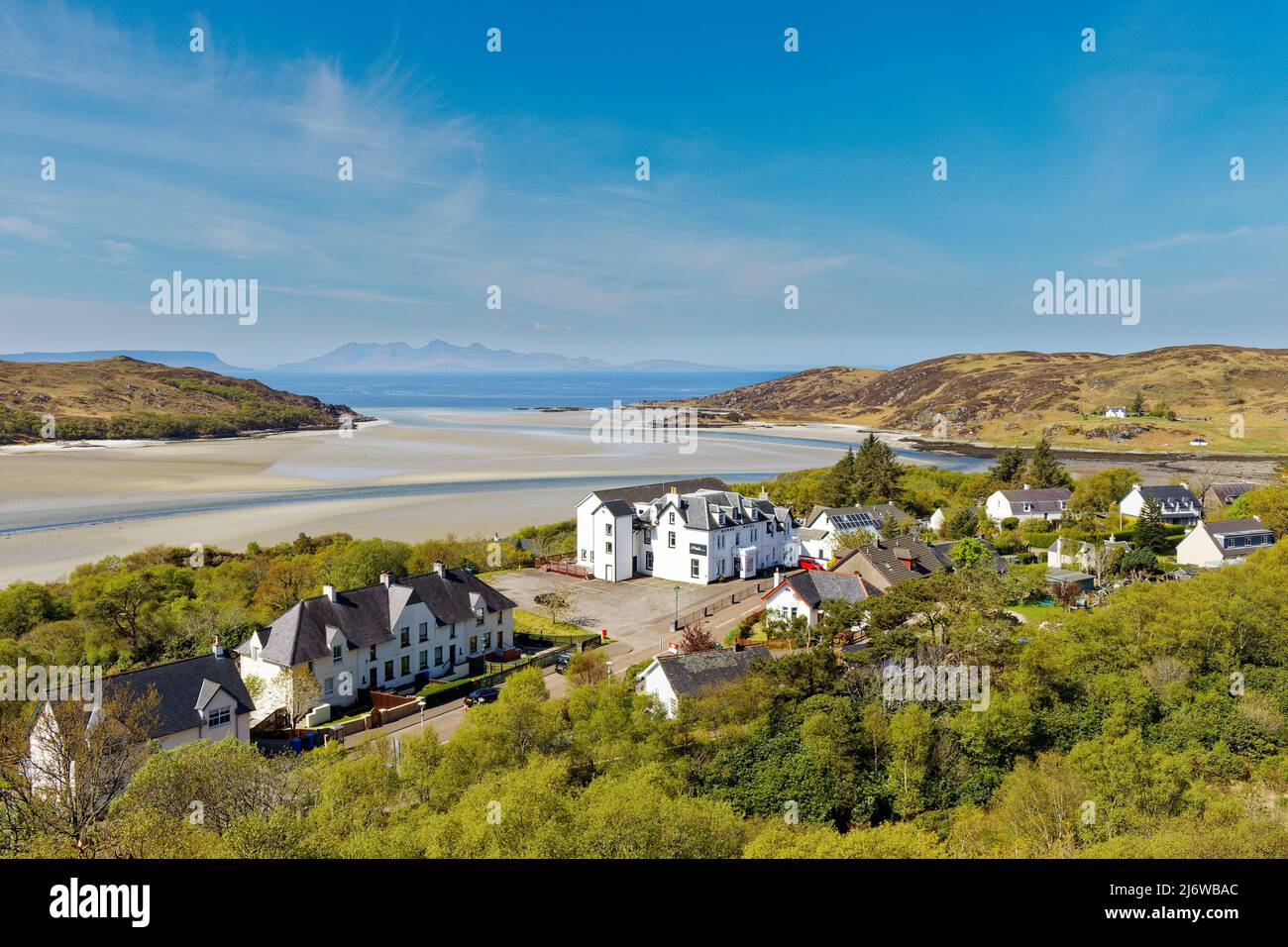 MORAR SCOTLAND THE VILLAGE HOUSES STATION AND HOTEL TREES IN SPRING  SANDY BEACH AND RUM ISLAND IN THE DISTANCE Stock Photo