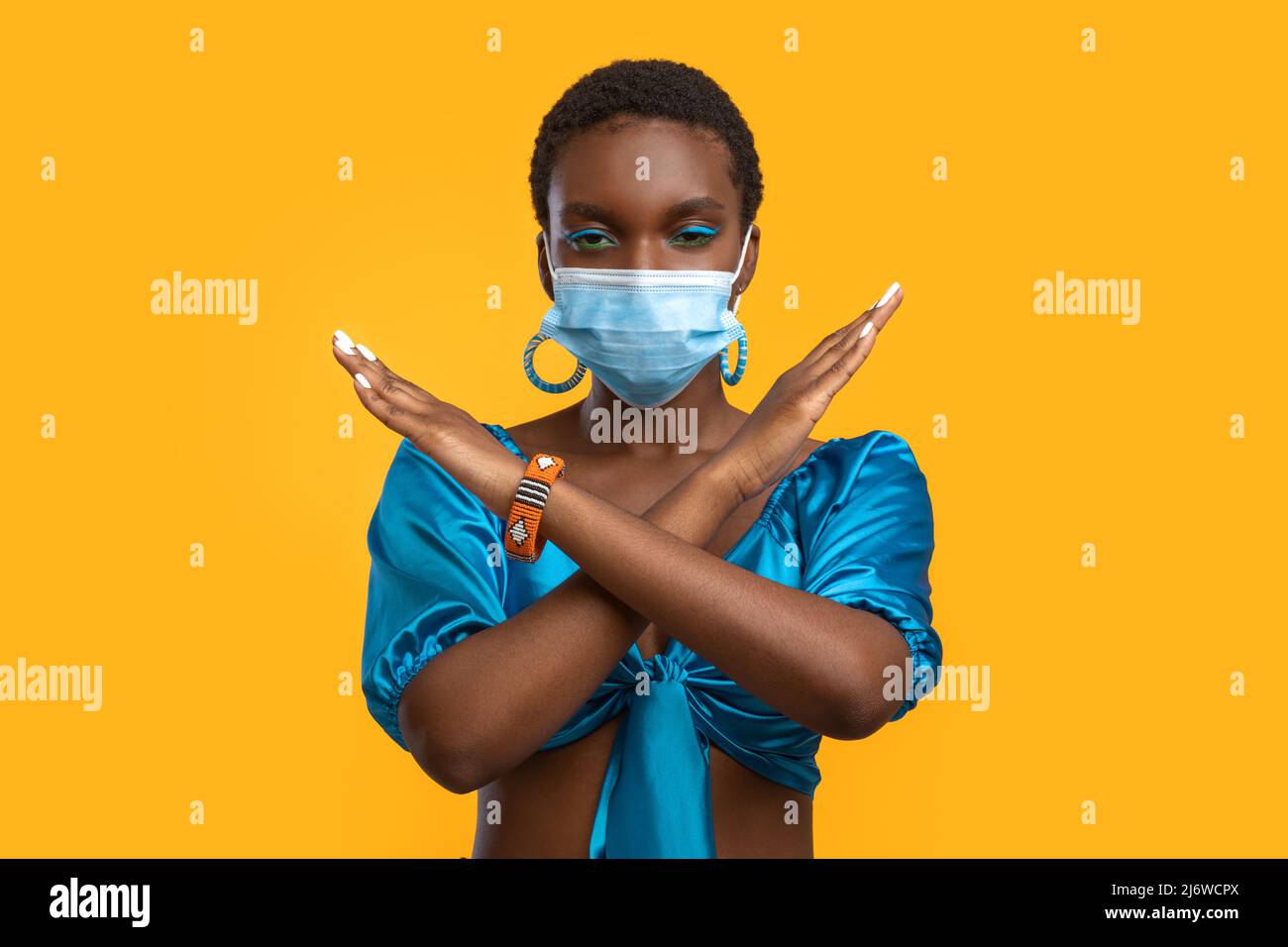 African american lady in face mask showing no gesture Stock Photo