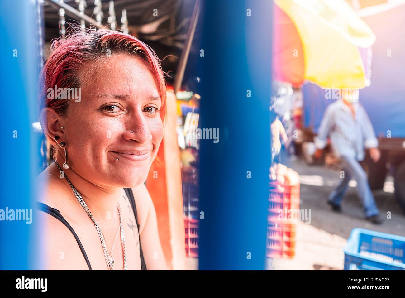 Portrait of a white Latin woman with a modern haircut with piercings on her lips and subtle tattoos in a popular market in Boaco Stock Photo