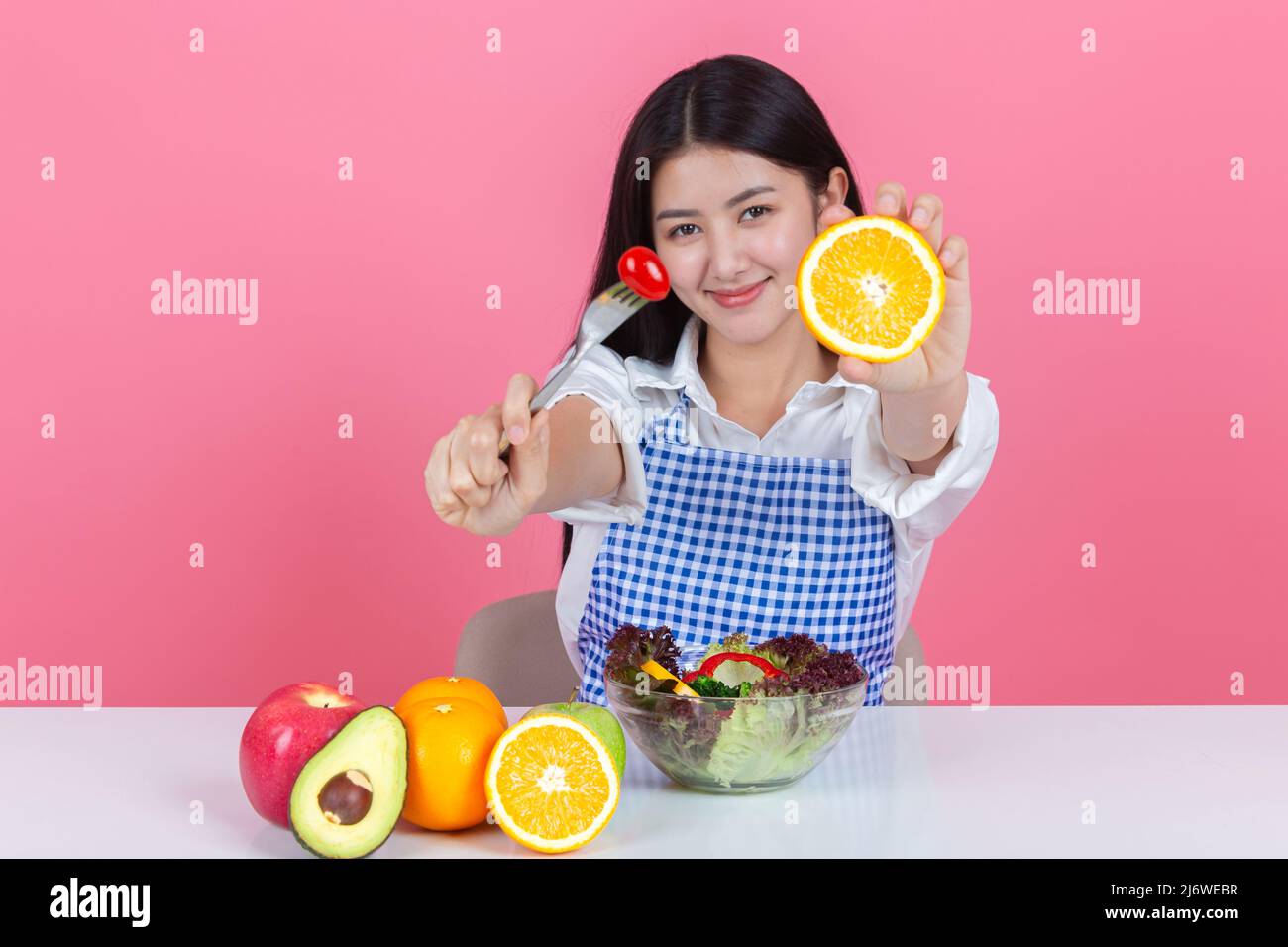 happy young asian woman choose to eat fresh orange apple fruits with ...