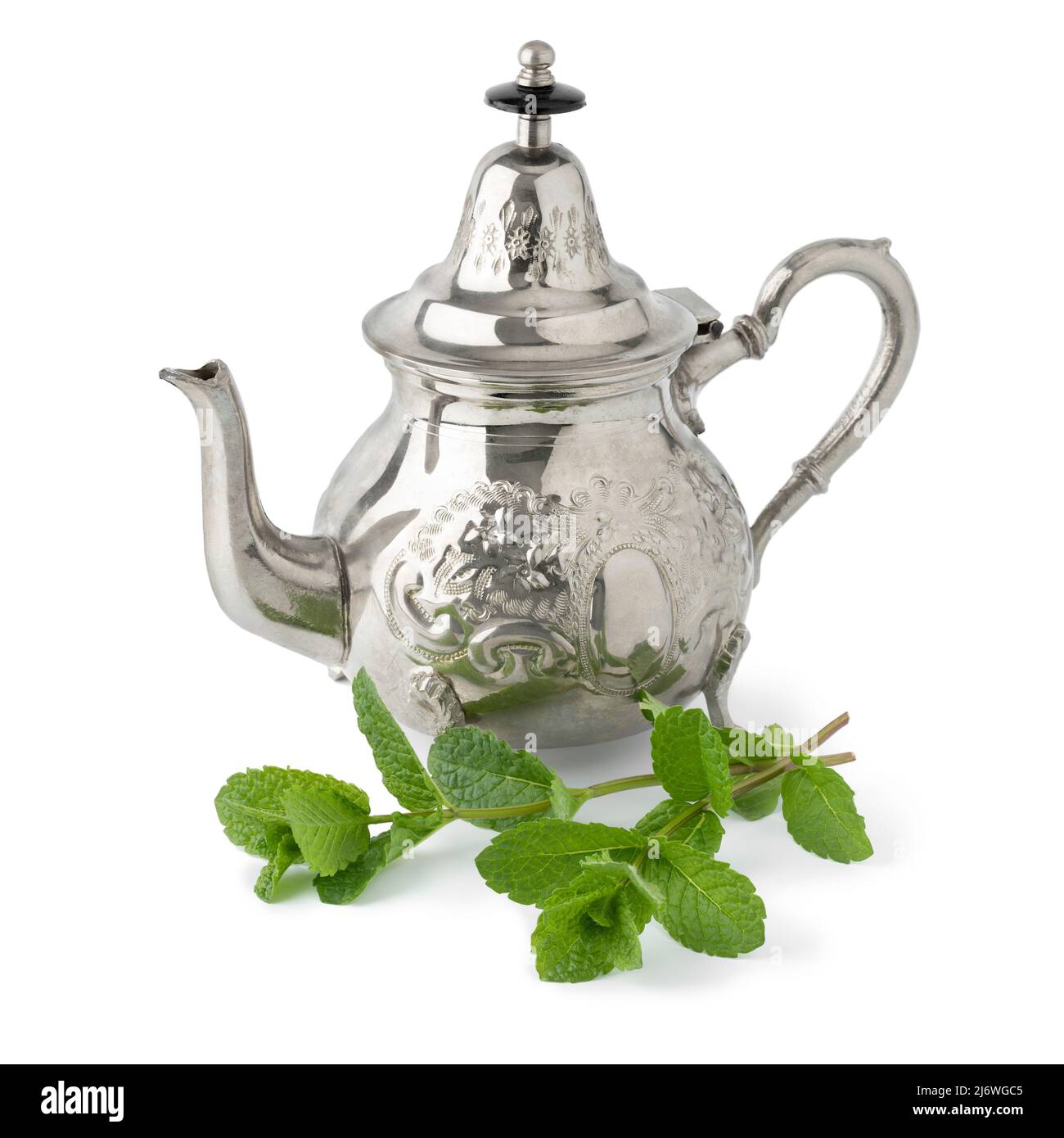 Moroccan teapot and twig of fresh mint isolated on white background Stock Photo