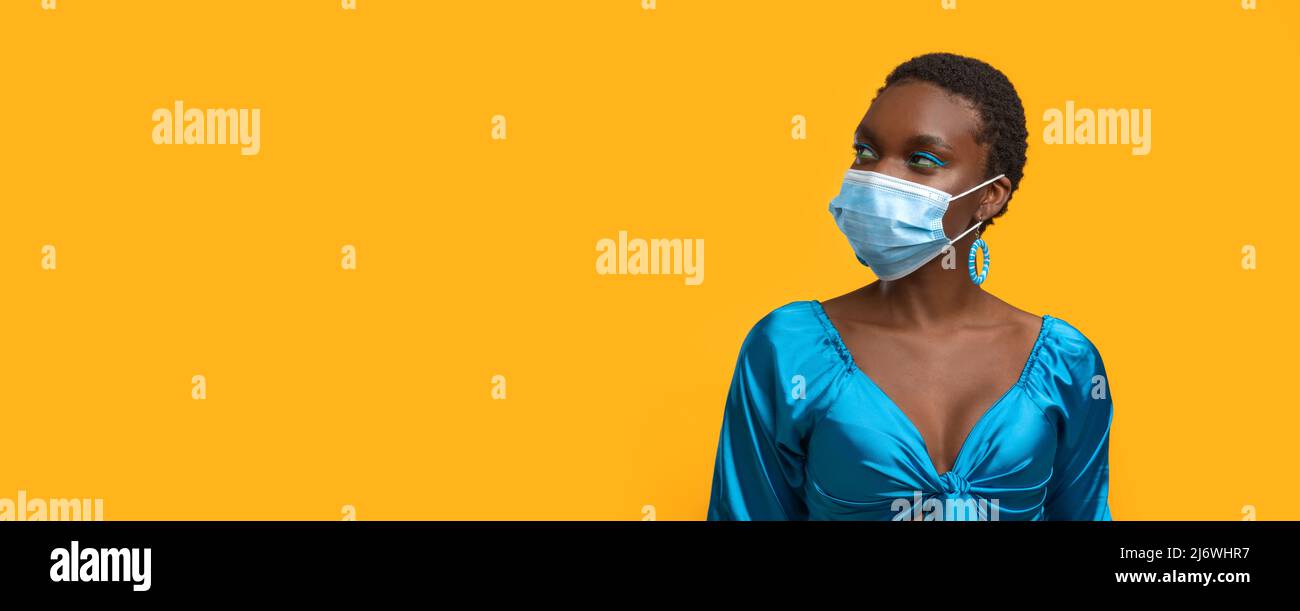 Short-haired black woman in face mask, panorama Stock Photo