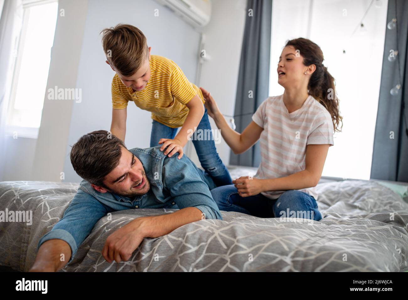 Young happy family having fun, playing together at home Stock Photo - Alamy