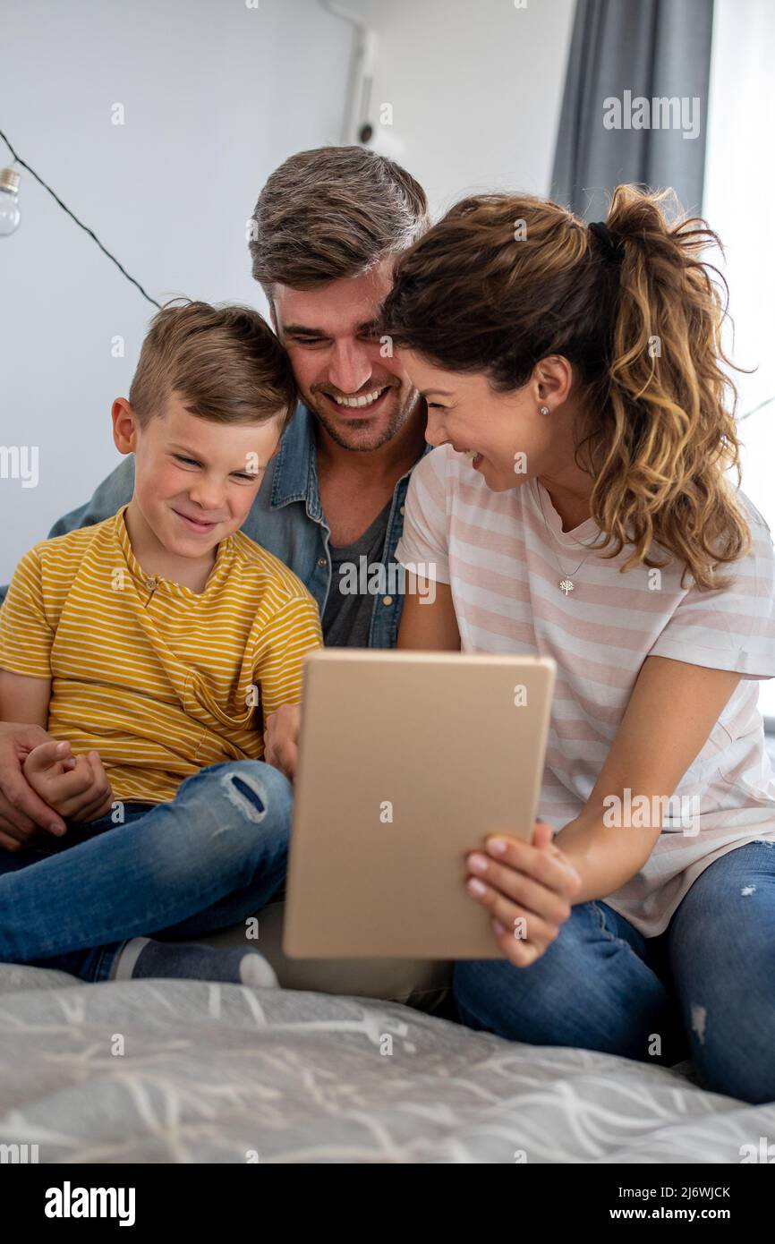Happy modern family using computer together at home Stock Photo - Alamy