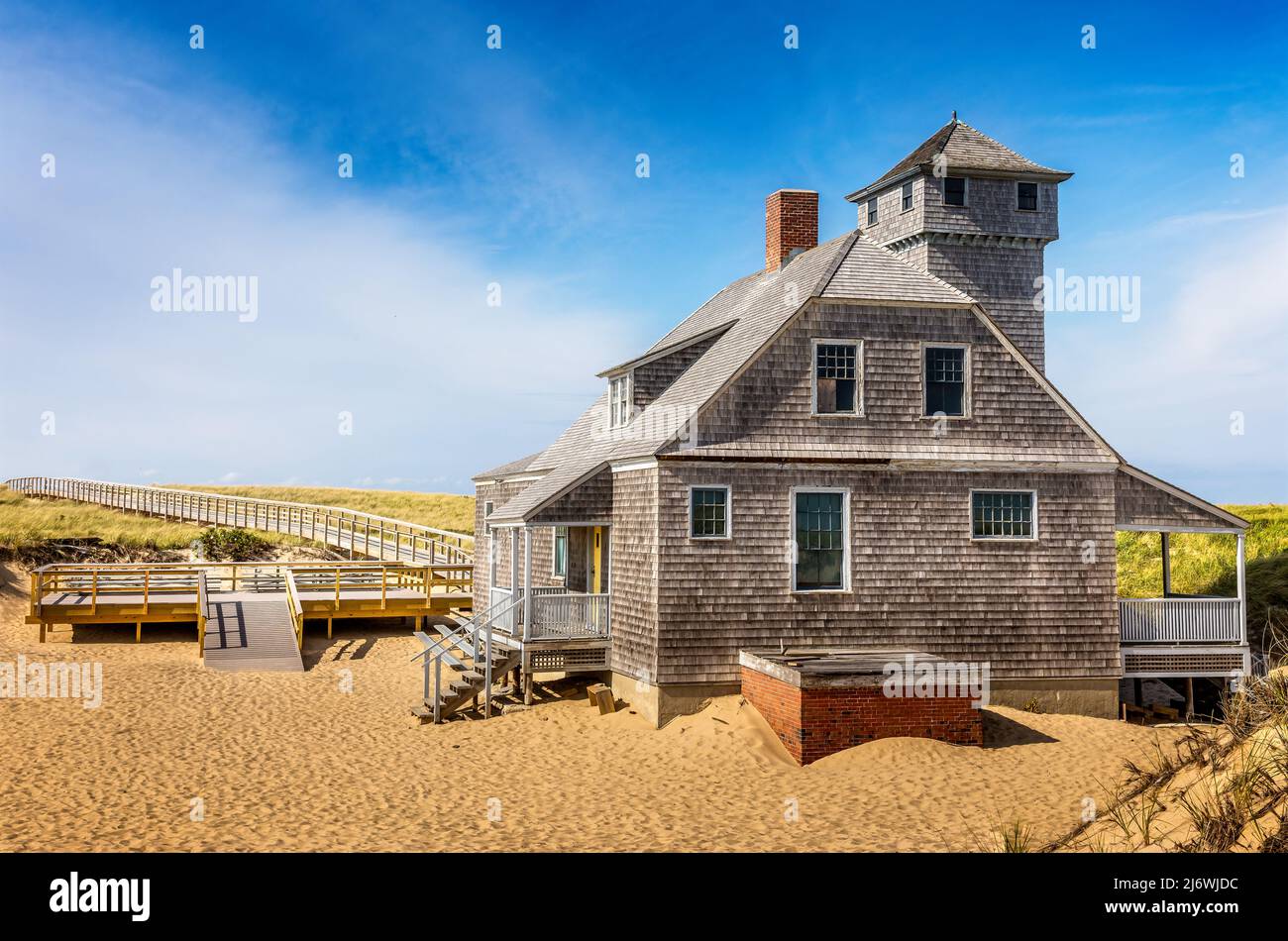 Blue sky and dunes with grass in front of the life saving station