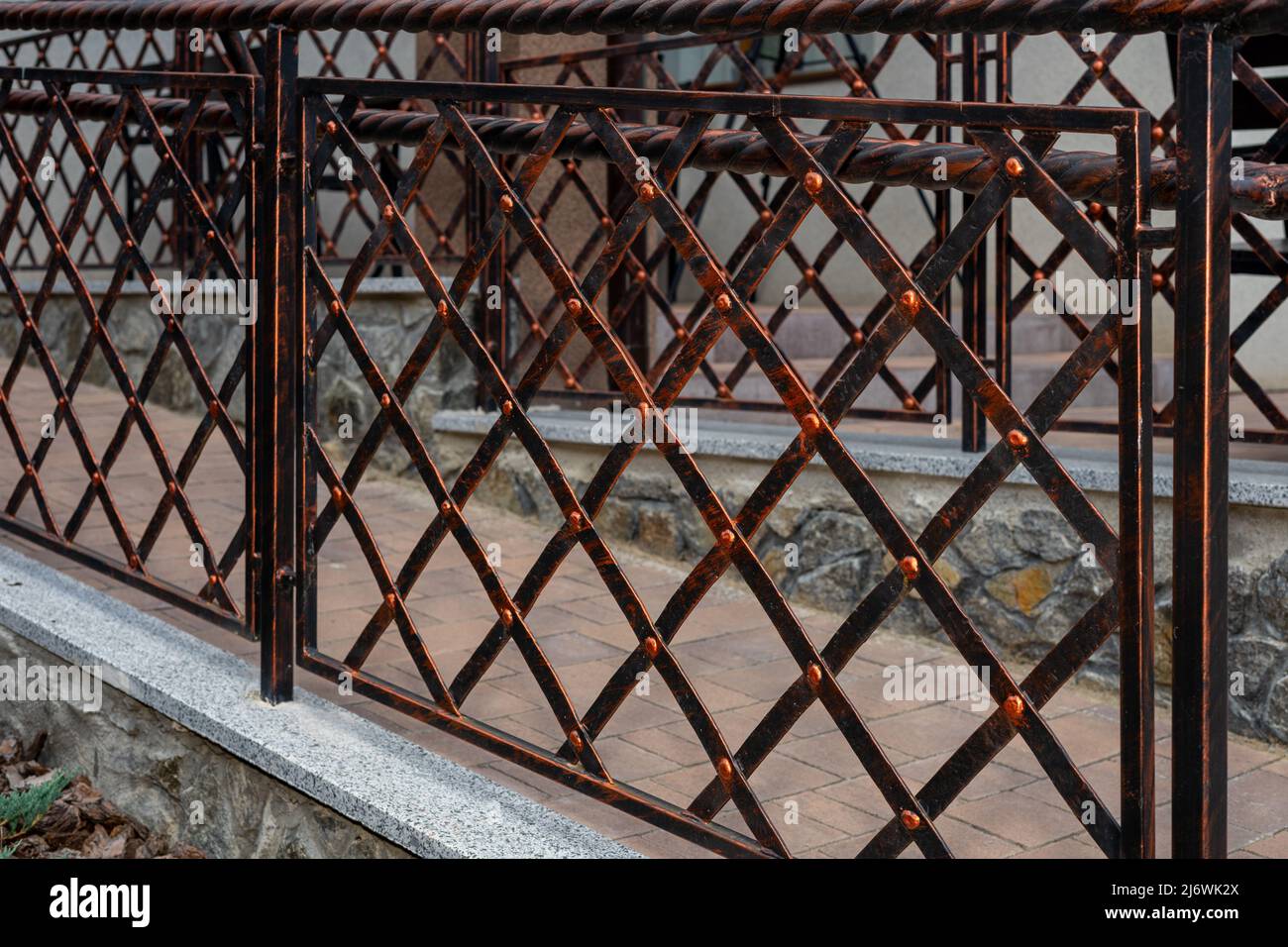 Iron fence with iron mesh. The appearance of the fence. Registration of the house territory Stock Photo