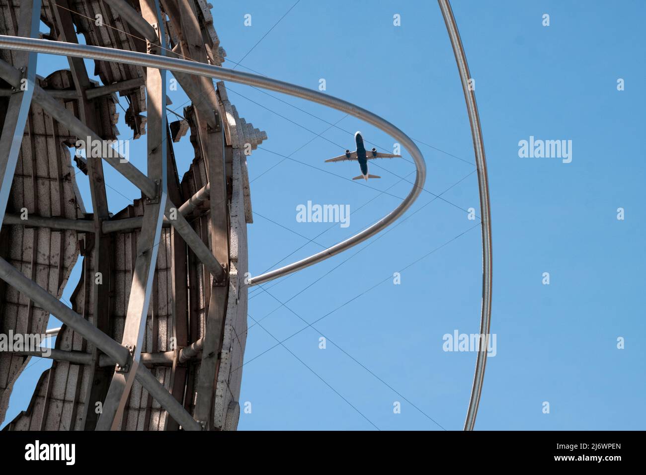 A plane taking off from LaGuardia Airport in Queens as seen through the Unisphere in Flushing Meadows Corona Park. Stock Photo