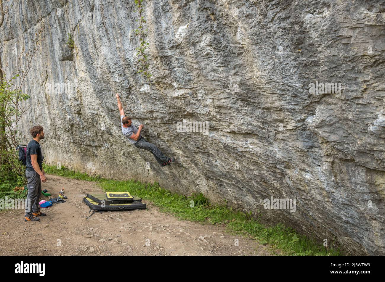 Boldering on a exposed limestone rock face in the Tideswell Dale in the Peak district national park, Derbyshire, England. Stock Photo