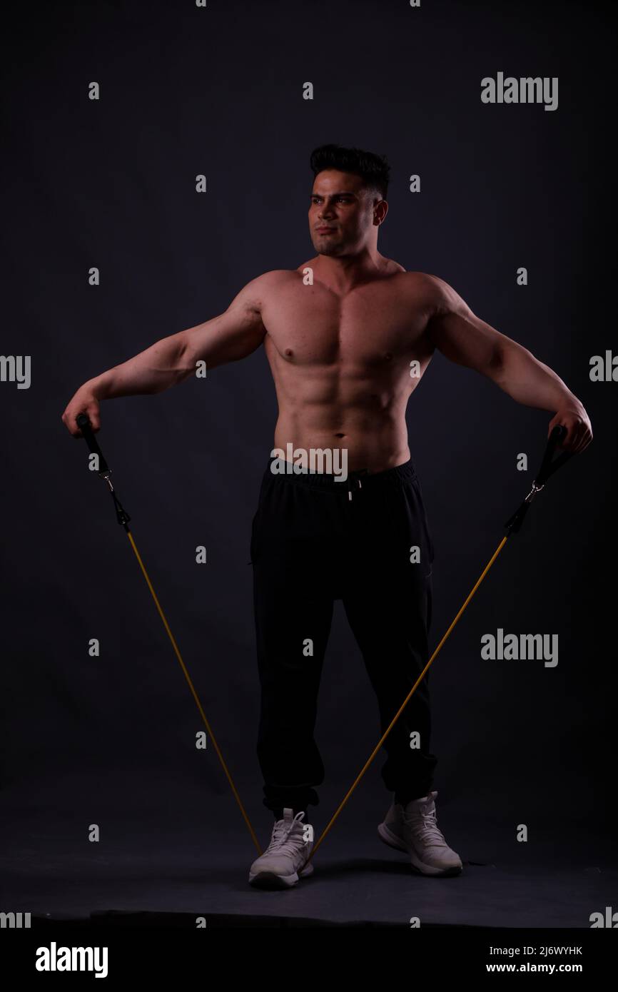 April 10 2022 Gaziantep Turkey Gaziantep Turkey. A man exercises using various types of resistance bands. Resistance loops band tension bands with handles door anchor and ankle straps are all devices ...