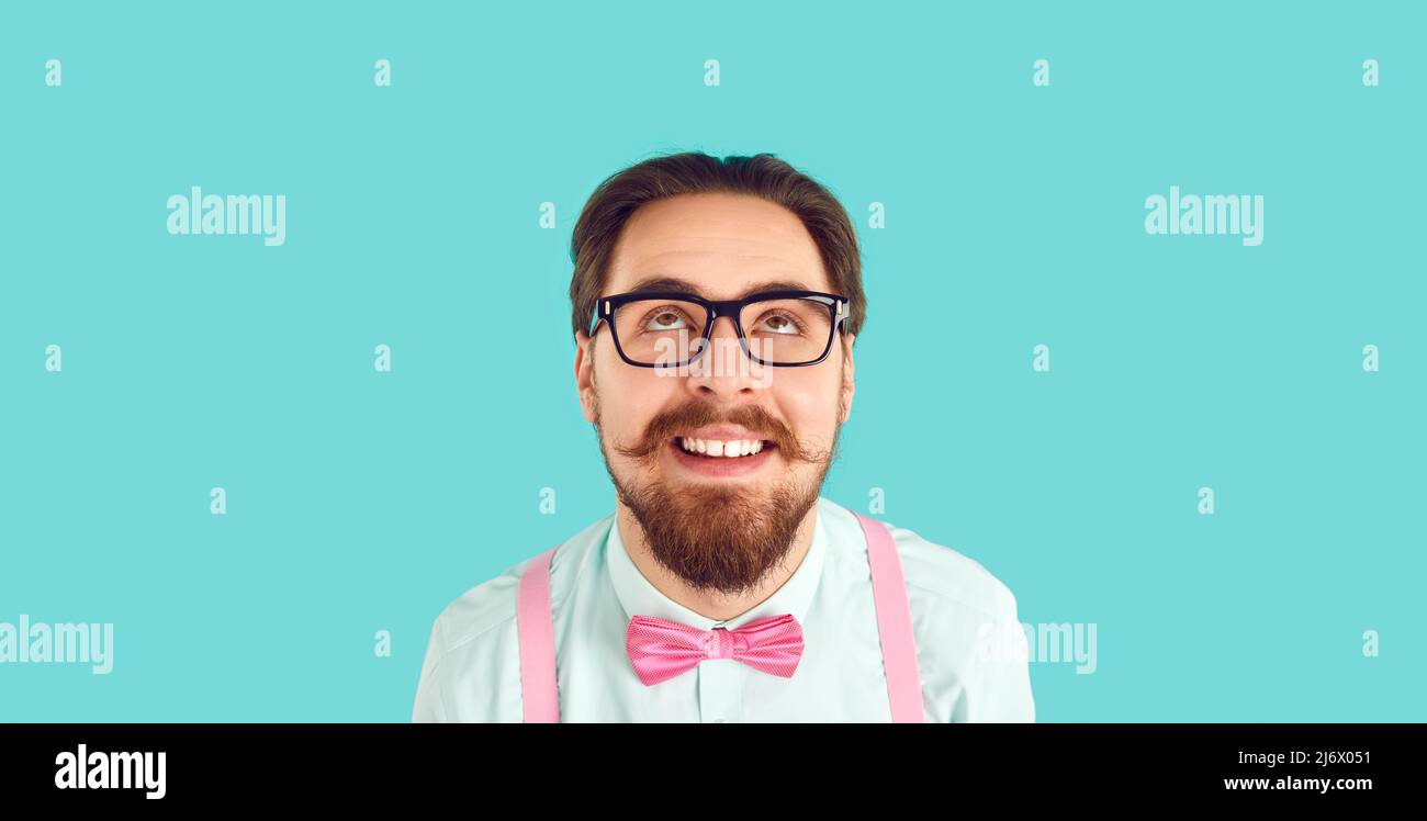 Funny bearded man in glasses look up thinking Stock Photo