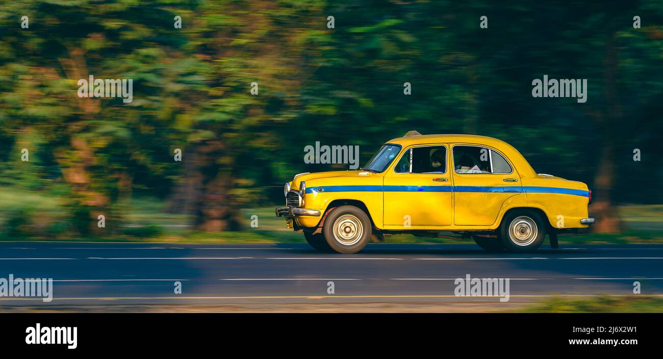 Yellow Taxi is a Heritage Transport System of West Bengal. Panning Shot is taken. Stock Photo