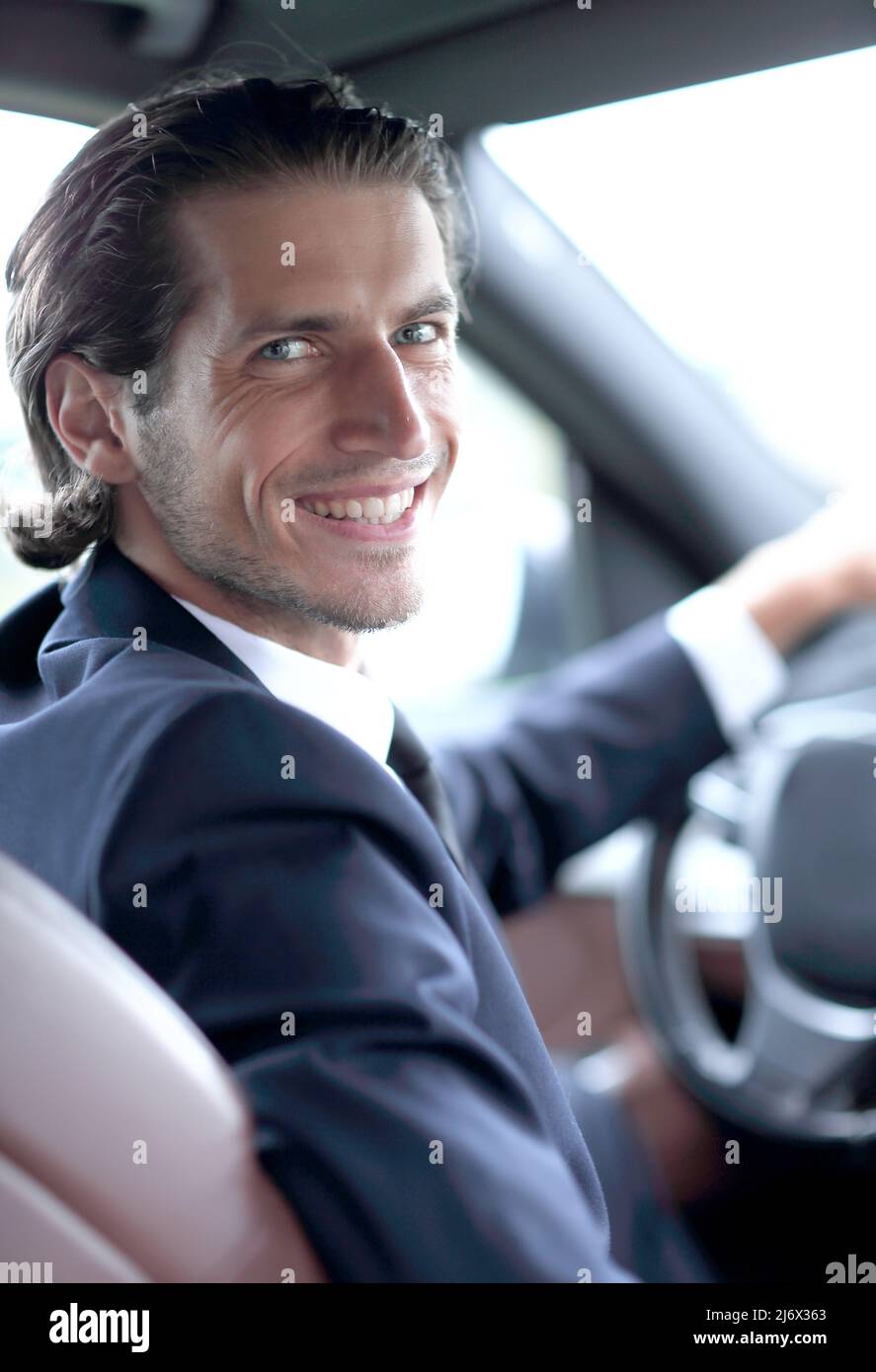 man sitting behind the wheel of a car Stock Photo - Alamy