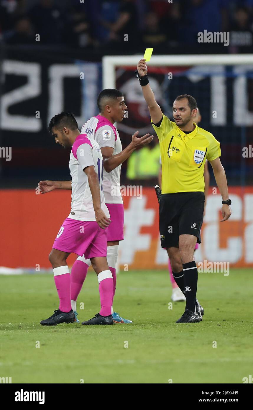 Leandro Velazquez of Johor Darul Tazim (L) was shown a yellow card by referee during the AFC Champions League Group I match between Johor Darul Tazim and Kawasaki Frontale at Sultan Ibrahim