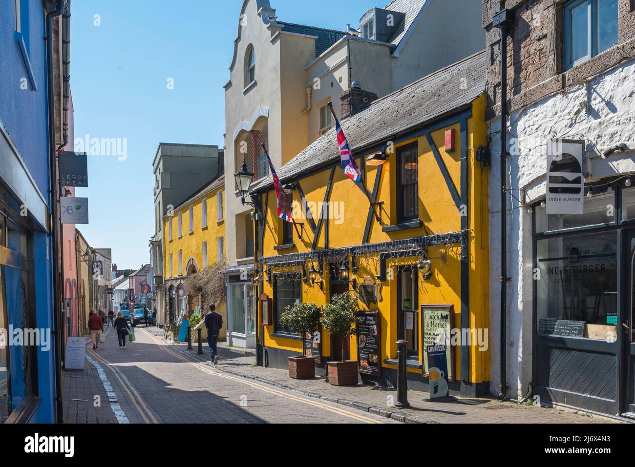 Tenby town centre, view of colourful shops in Upper Frog Street in the historic seaside town of Tenby, Pembrokeshire, Wales, UK Stock Photo