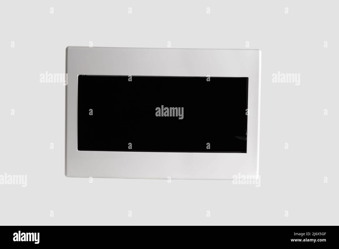 Plastic distribution board. Electrical board. Close-up. Isolated on light gray background. Stock Photo