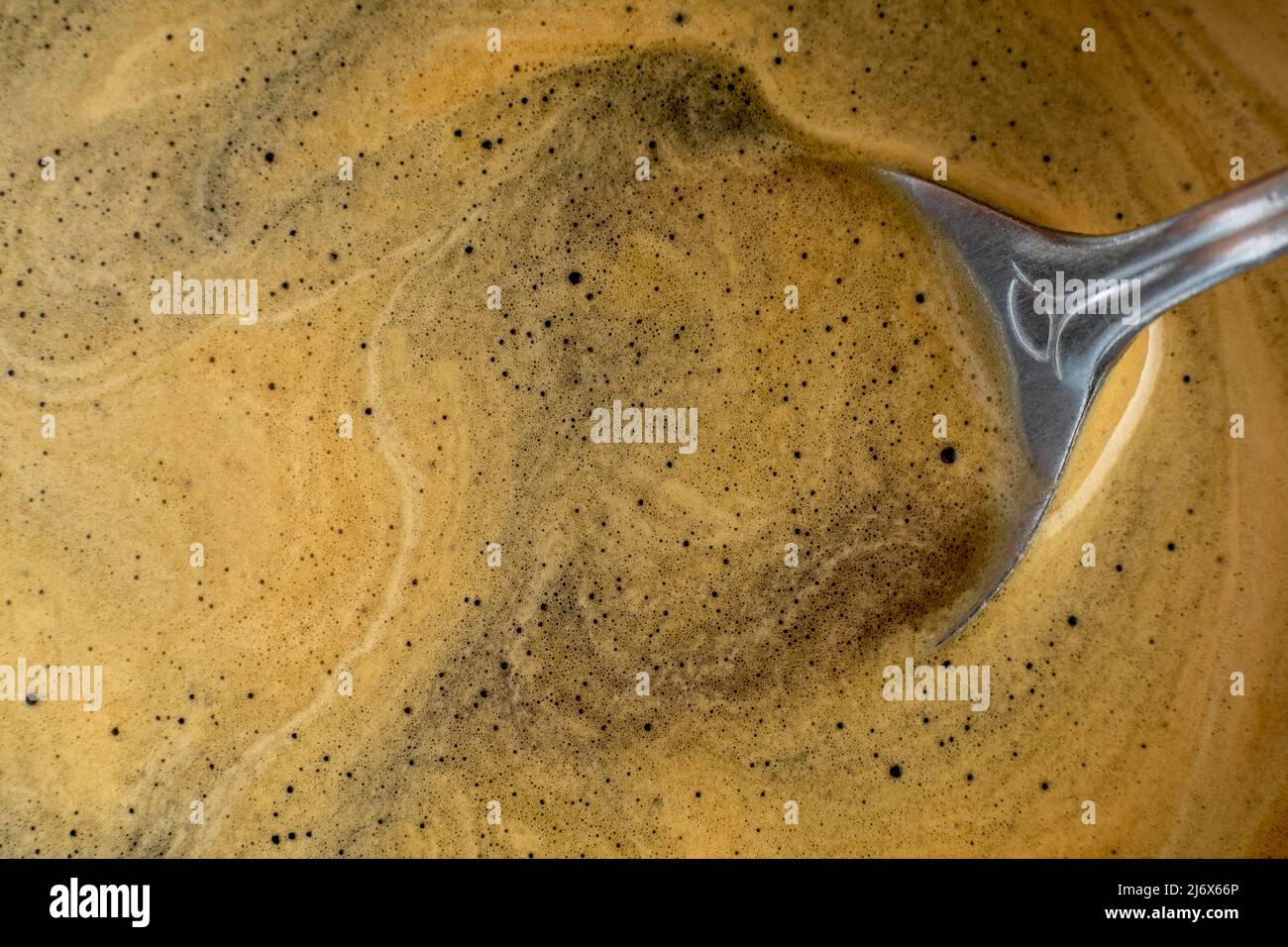 Coffee texture background. Strong espresso extreme dark coffee brown froth closeup Stock Photo