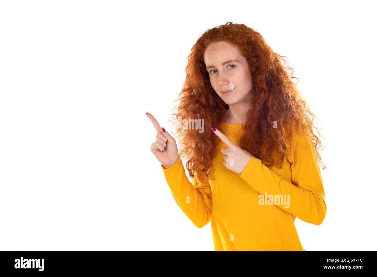 Photo of young cheerful good mood smiling young girl point finger copyspace advertisement isolated on white color background Stock Photo