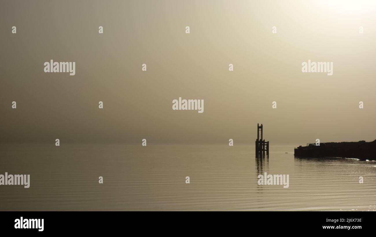 Sea in calm. Monochromatic Image. Misty morning in the beach. Kuwait Stock Photo