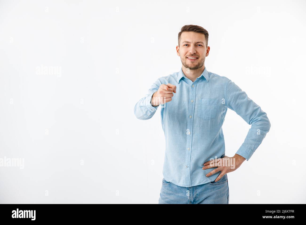 A young man in a blue shirt gestures. Motivational poster, are you ready. Copy Space. Stock Photo