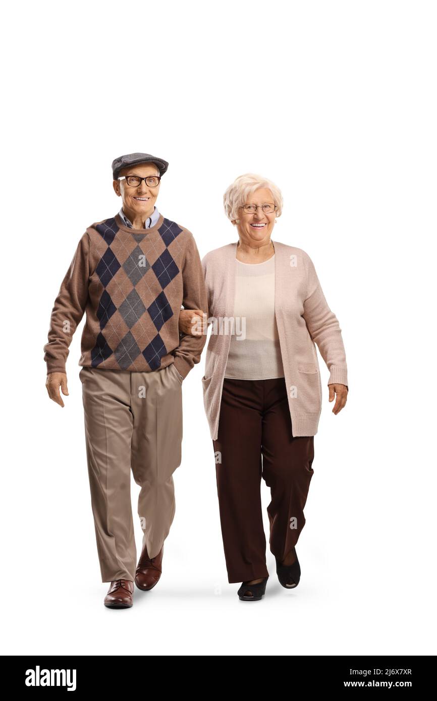 Full length portrait of an elderly couple walking towards camera and smiling isolated on white background Stock Photo
