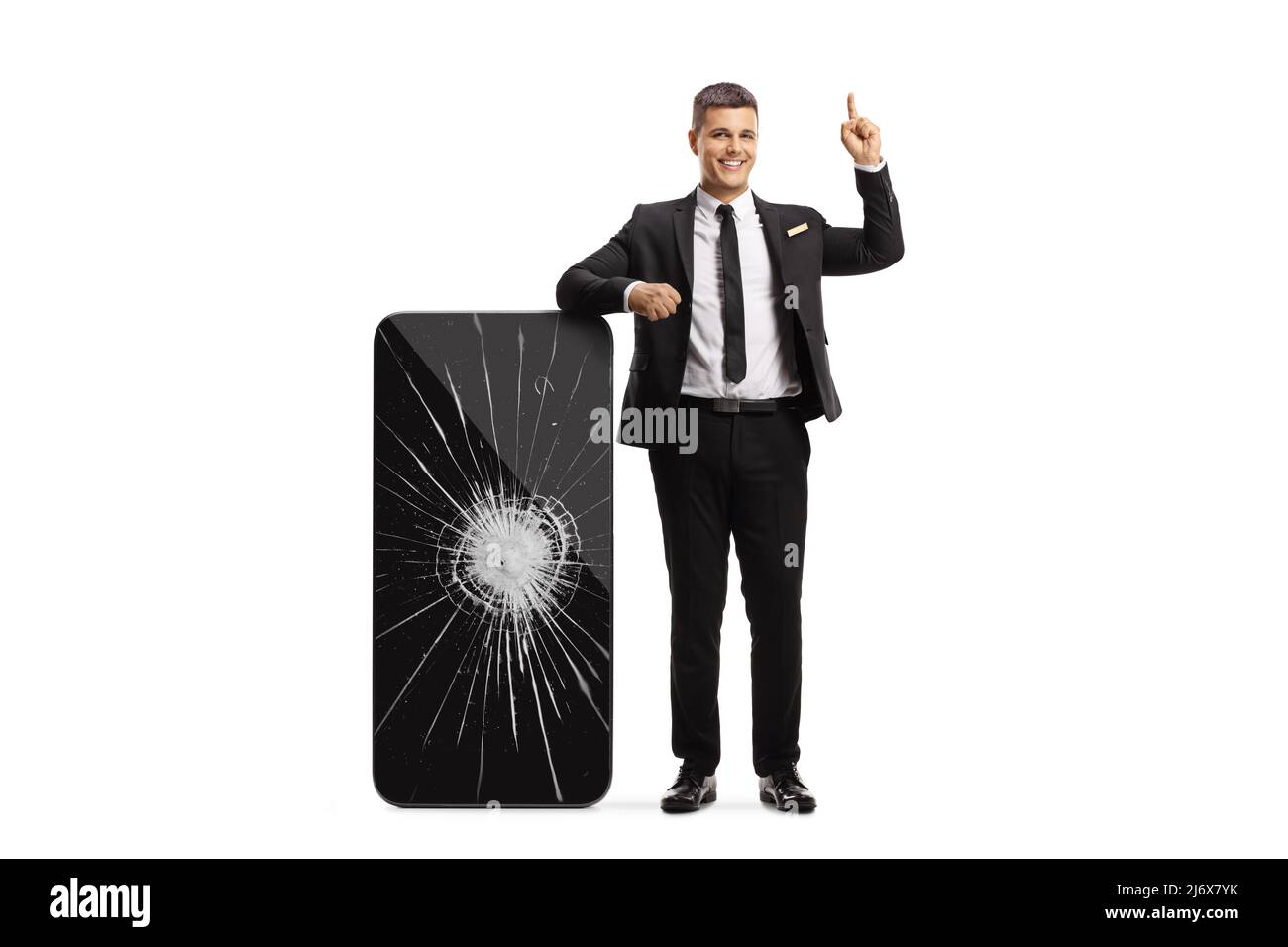 Manager leaning on a big smartphone with a broken screen and pointing up isolated on white background Stock Photo