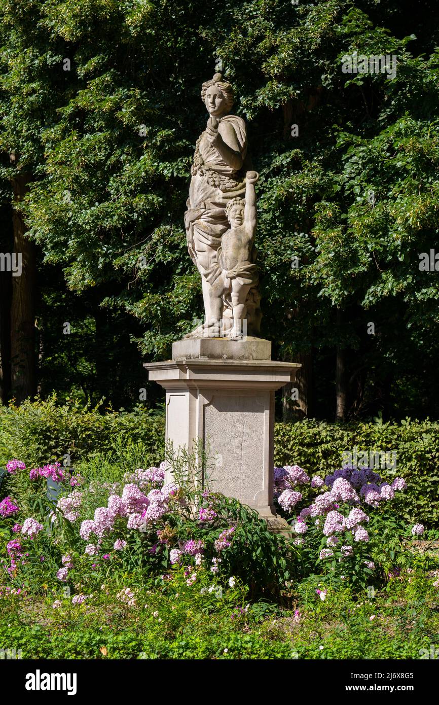 Statue of Flora (Pomona) with Putto, Goddess of flowers and the season of spring in Roman mythology in Rose Garden of Tiergarten park in Berlin, Germa Stock Photo