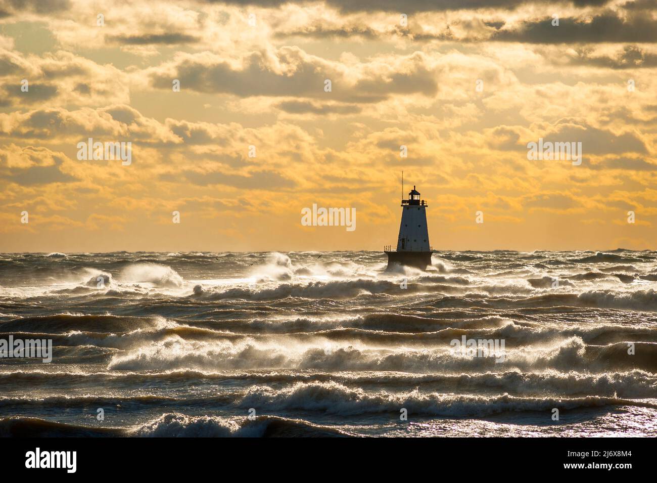 Beautiful sunset over the north breakwall lighthouse at Streans Park in Ludington, Michigan, USA. Stock Photo