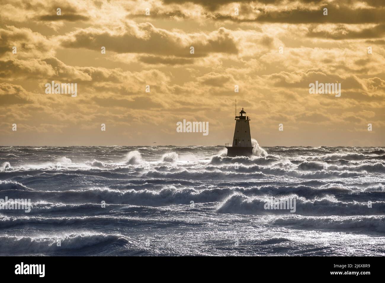 Beautiful sunset over the north breakwall lighthouse at Streans Park in Ludington, Michigan, USA. Stock Photo