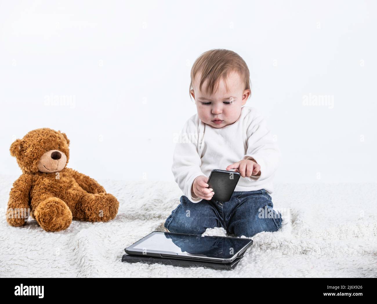 Stock studio photo with a white background of a baby touching the ...