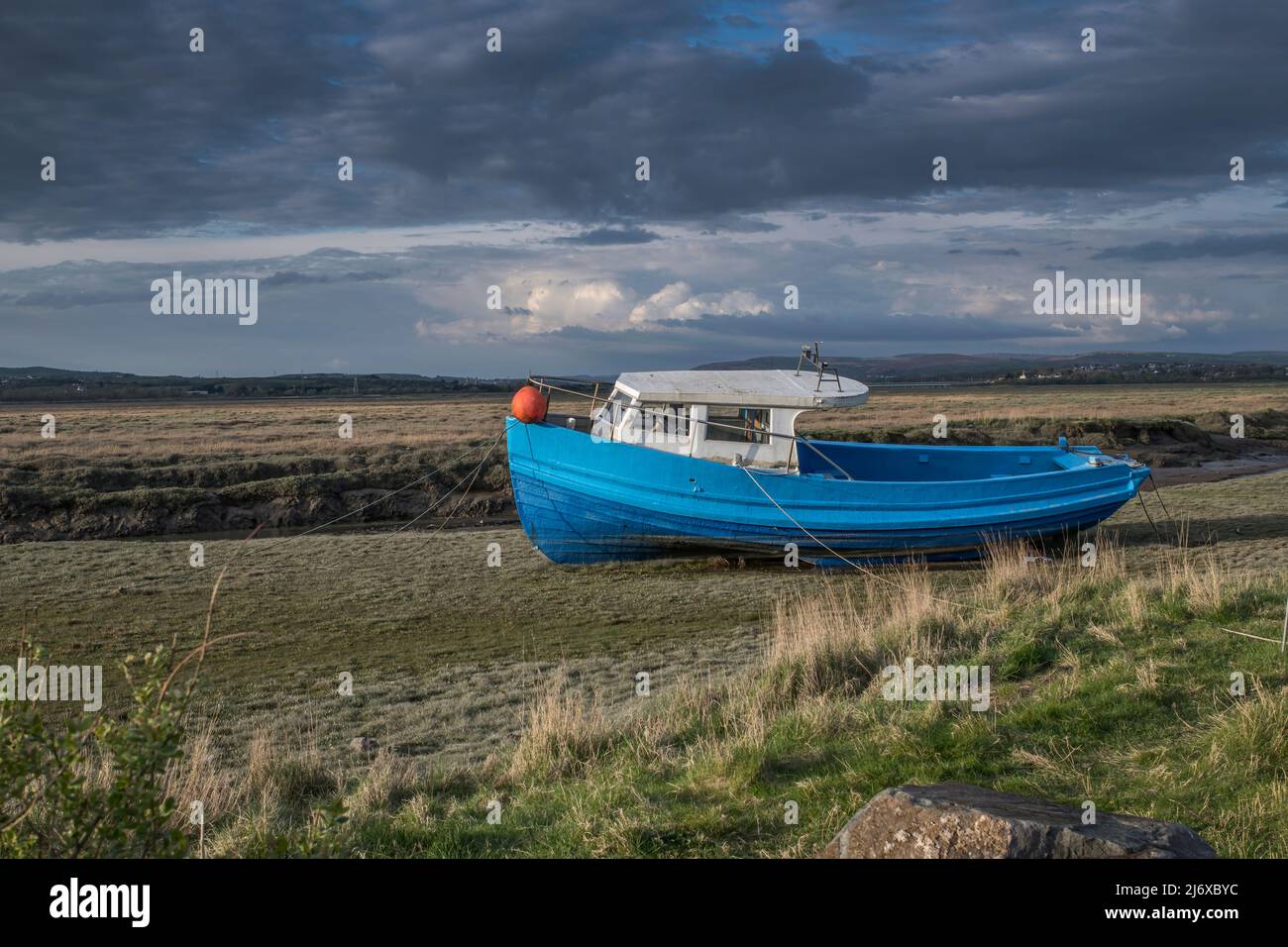 Old fishing boat at  river loughor estuary in the Gower South Wales waiting for the tide to come in Stock Photo