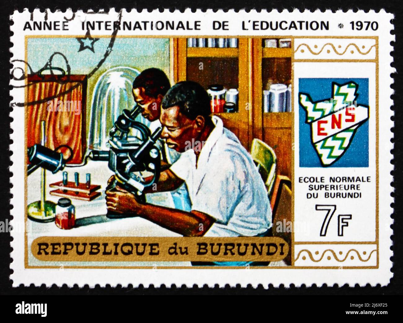 BURUNDI - CIRCA 1970: a stamp printed in Burundi shows Students in Laboratory and Emblem of Ecole Normale Superieure of Burundi, circa 1970 Stock Photo