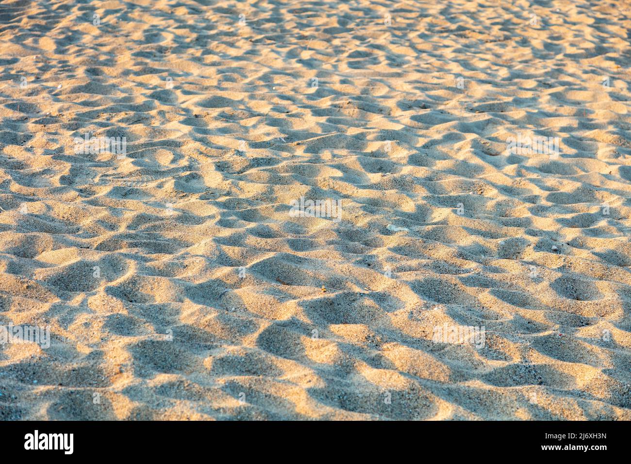 Sand texture background. Sandy beach rough surface. Natural material above view. Summer vacation concept. Stock Photo