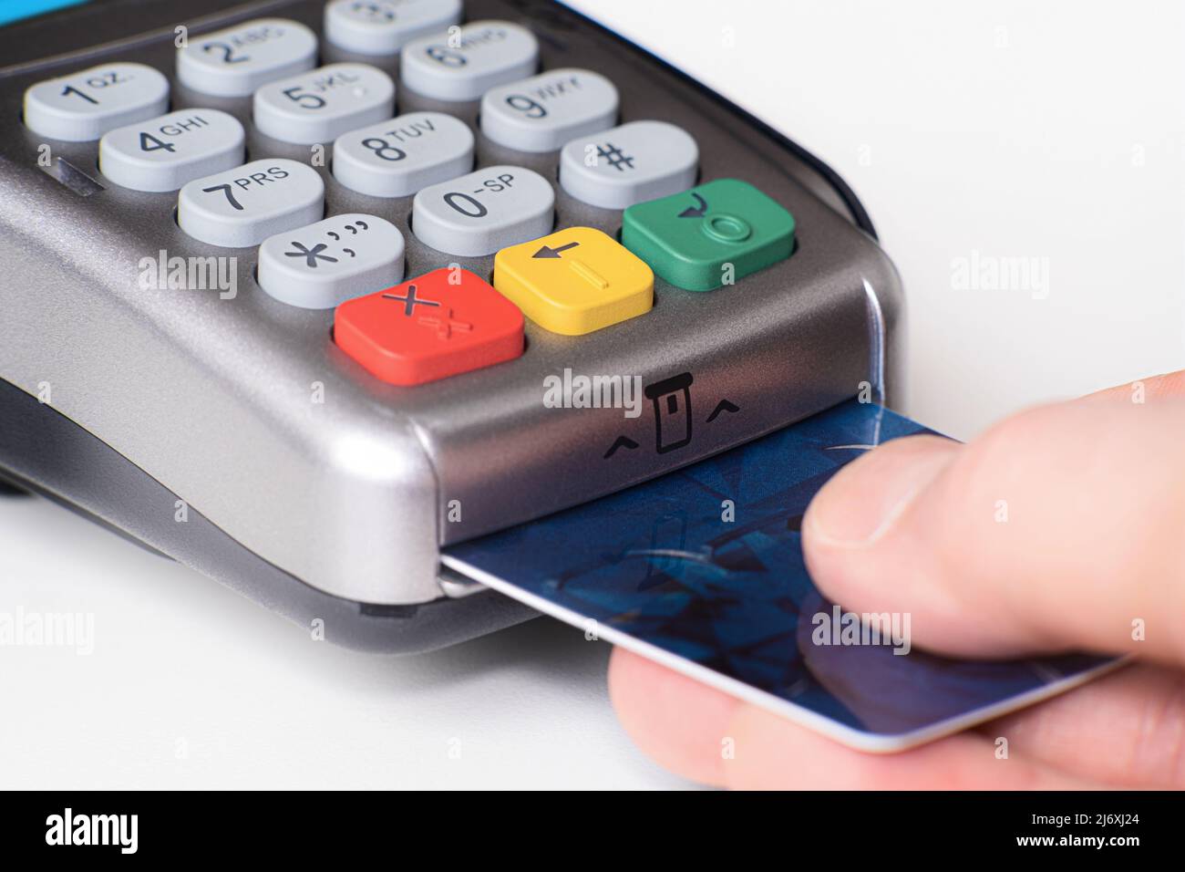 Plastic card in hand, credit card payment through the terminal, Purchase and sale of goods and services, selective focus, Financing concept Stock Photo