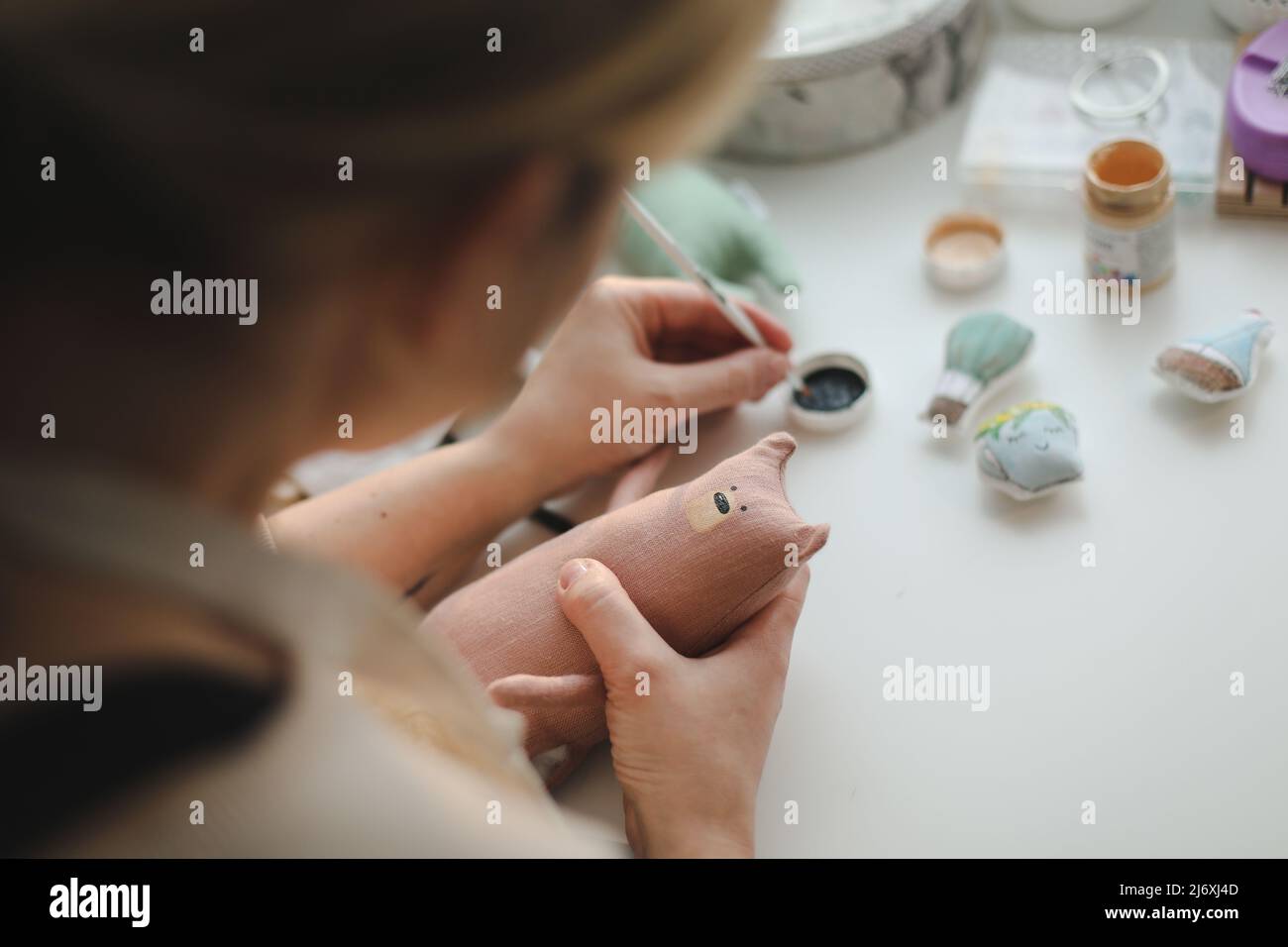 Process of making toy, top view. Woman hands making handmade teddy toy ...