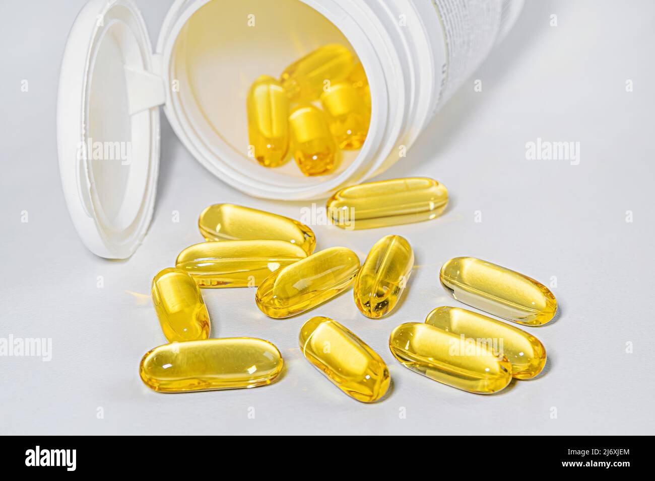 The concept of healthy nutrition, diet and omega-3 supplements - close-up of capsules poured out of a jar Stock Photo