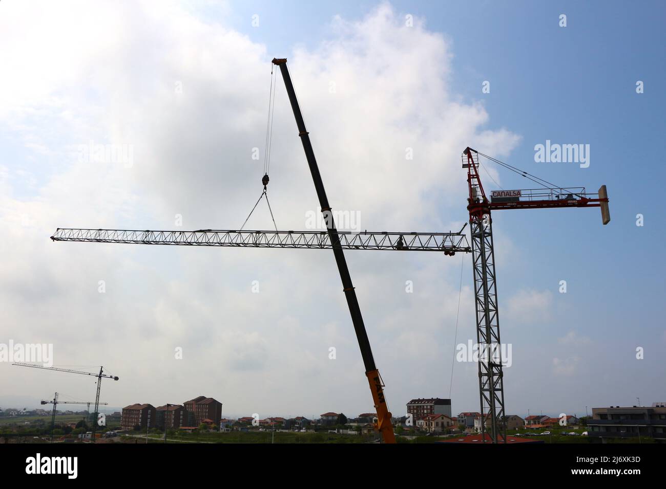 Horizontal jib of a tower crane being lifted into position by a truck ...