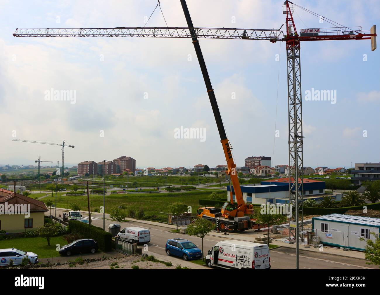 Horizontal jib of a tower crane being lifted into position by a truck ...