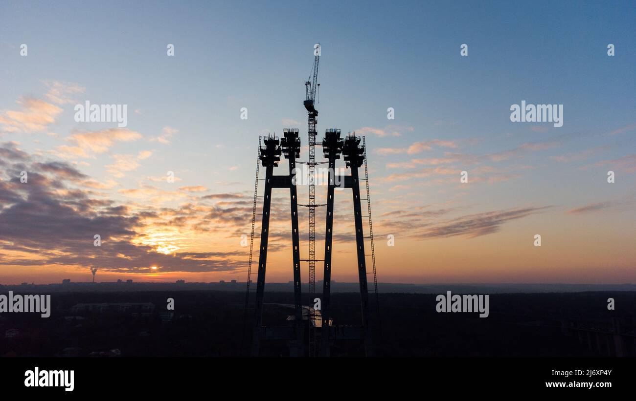Tall construction crane against the blue sky. Tower crane for lifting
