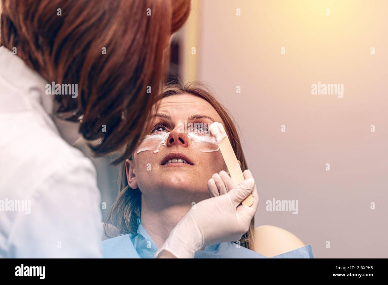 Local anesthesia before anti aging eye treatments Stock Photo