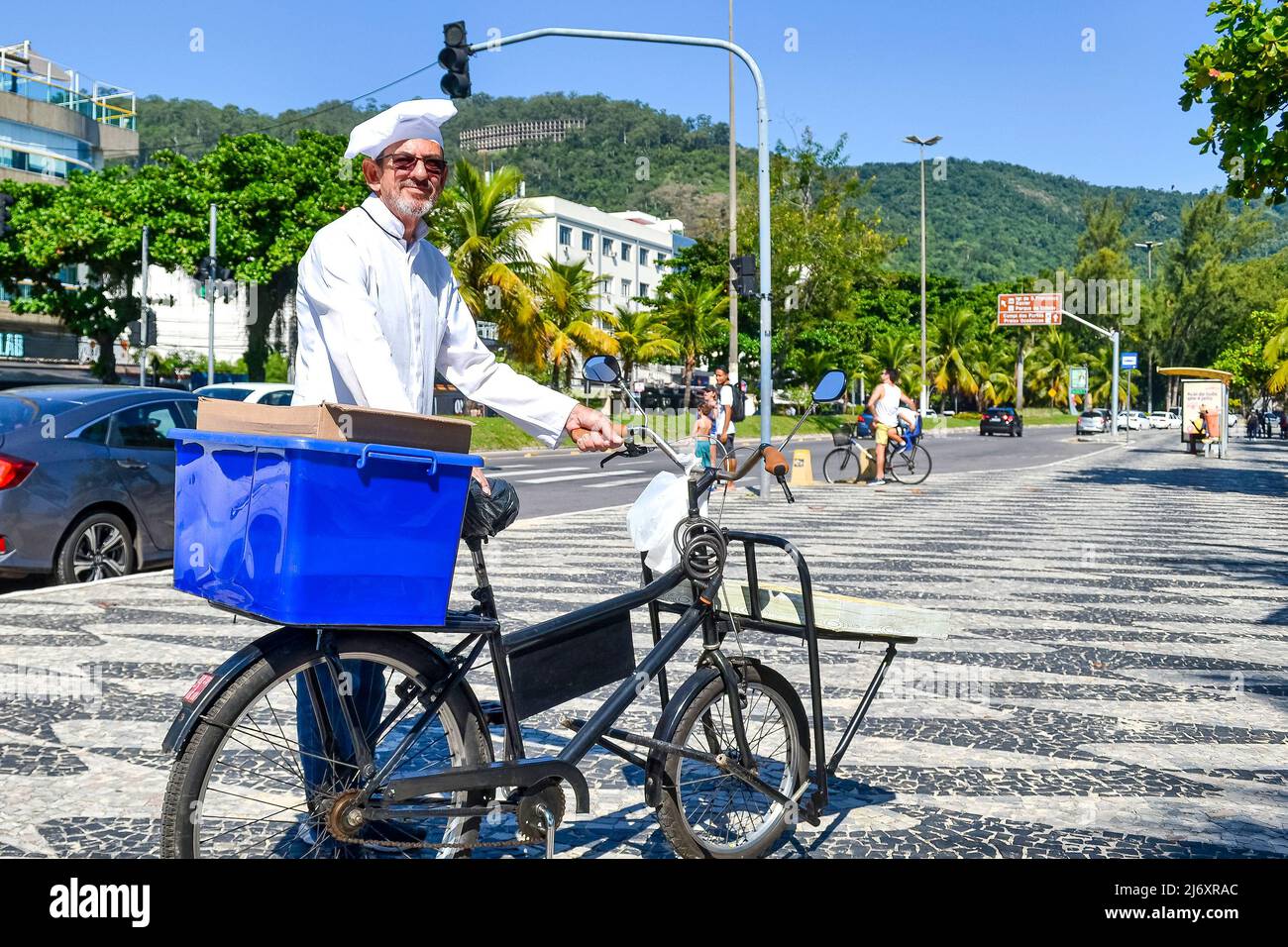 Brazilian man dressed as a chef and selling food in a bicycle in Icarai Beach. This area is a tourist attraction in Rio de Janeiro state Stock Photo