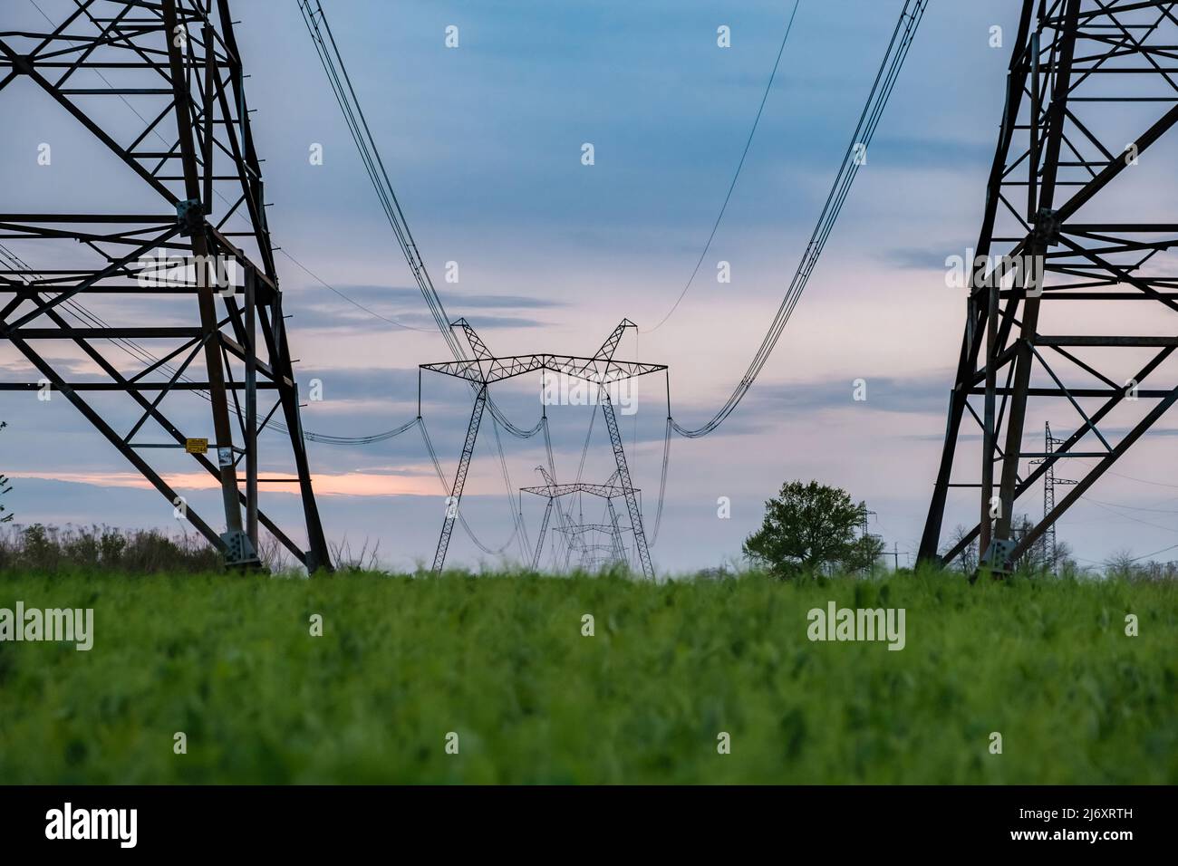 Power line posts. high voltage tower with the sky. Electricity pylon with beautiful calm sky on the background. Electrical pylons Stock Photo