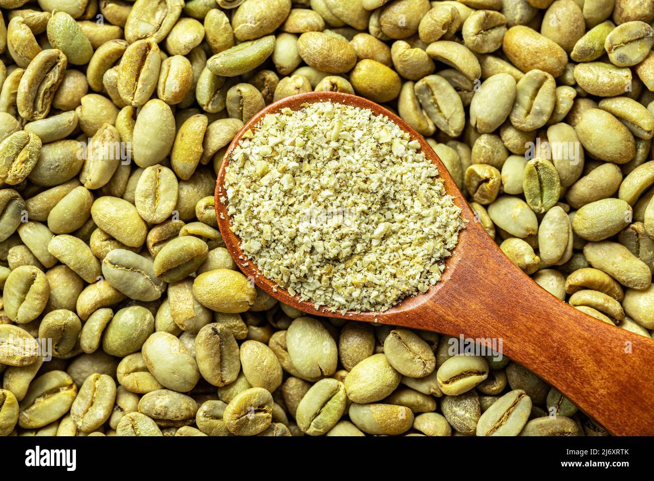 Ground green coffee in scoop and unroasted coffee beans. Top view Stock  Photo - Alamy
