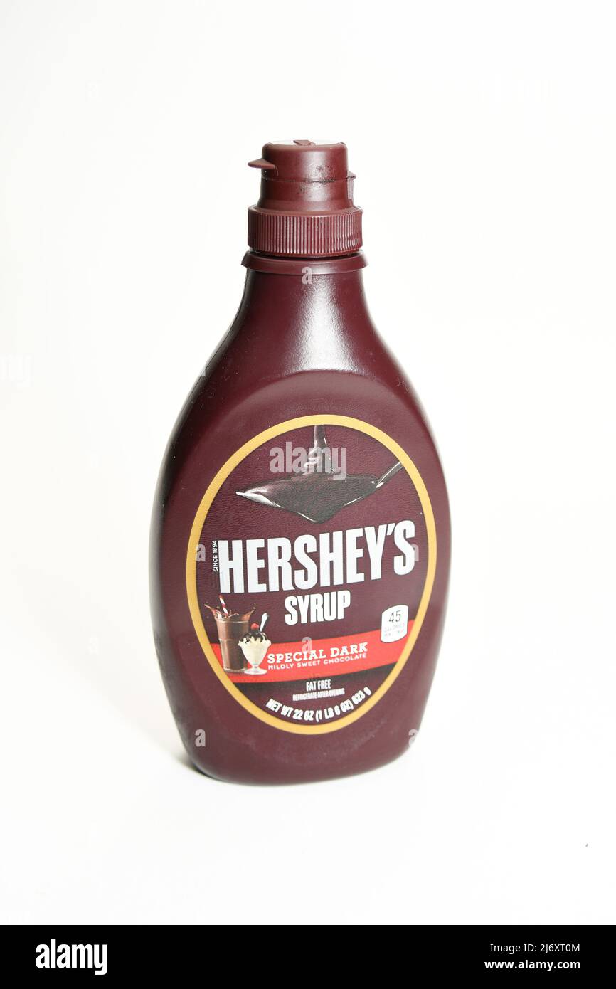 Plastic squeeze bottle of Hersey's chocolate syrup used for toppings on ice-cream or other desserts isolated on white background Stock Photo
