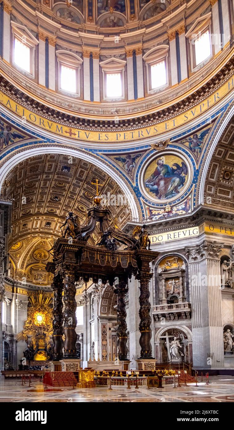Rome, Italy - May 27, 2018: Presbytery and apse with St. Peter's Baldachin of Bernini altar bronze canopy in St. Peter's Basilica, San Pietro of Vatic Stock Photo