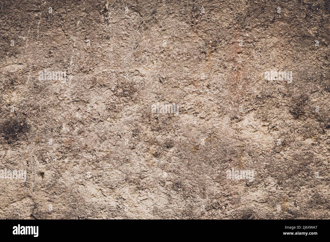 Closeup detail of old brown stucco clay wall, abstract rough surface background or grunge backdrop with vignette effect, architectural material Stock Photo