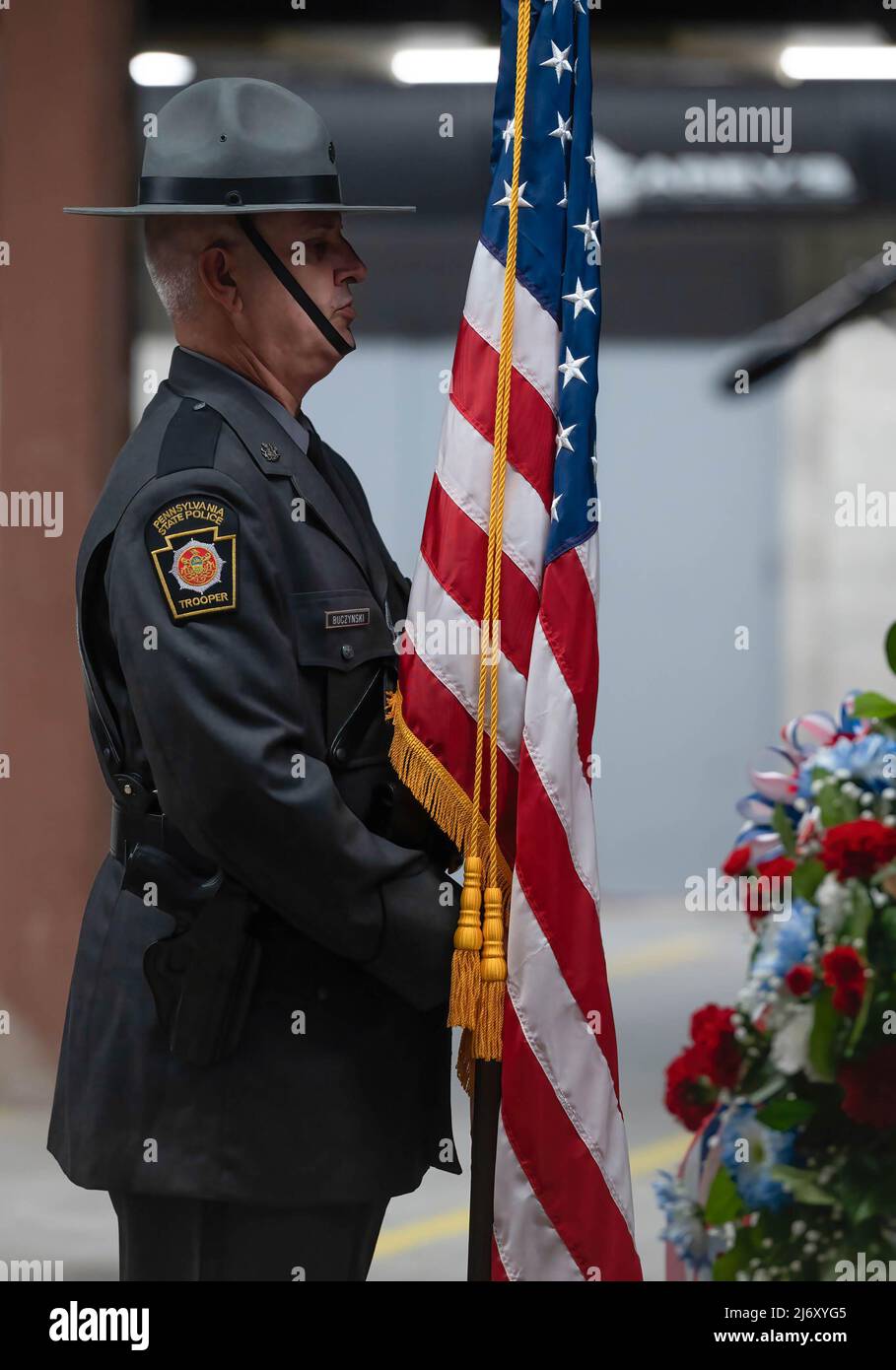 A Pennsylvania State Police Trooper places the American Flag at the PA