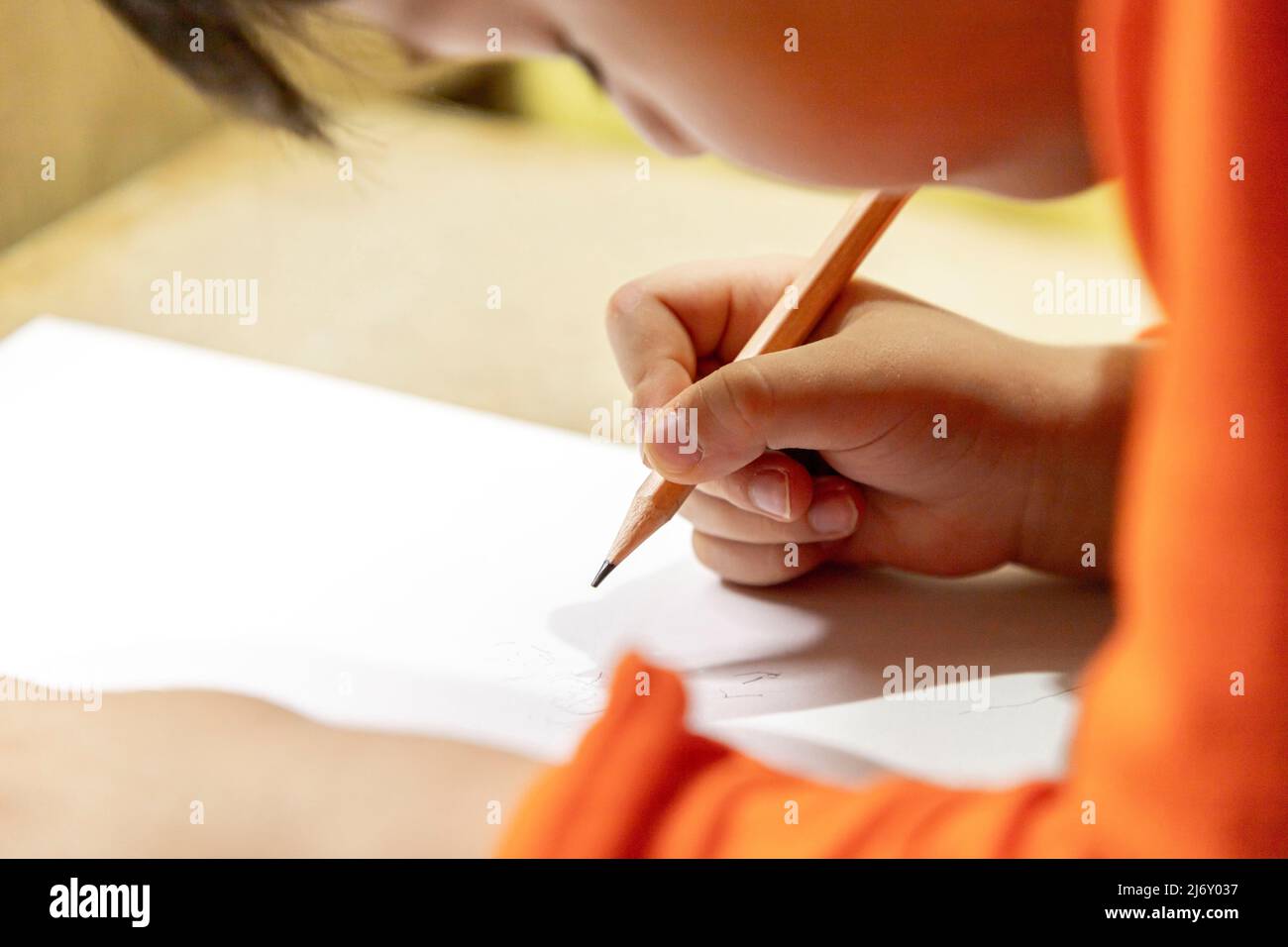 Little boy scribbling with pen on paper Stock Photo Alamy